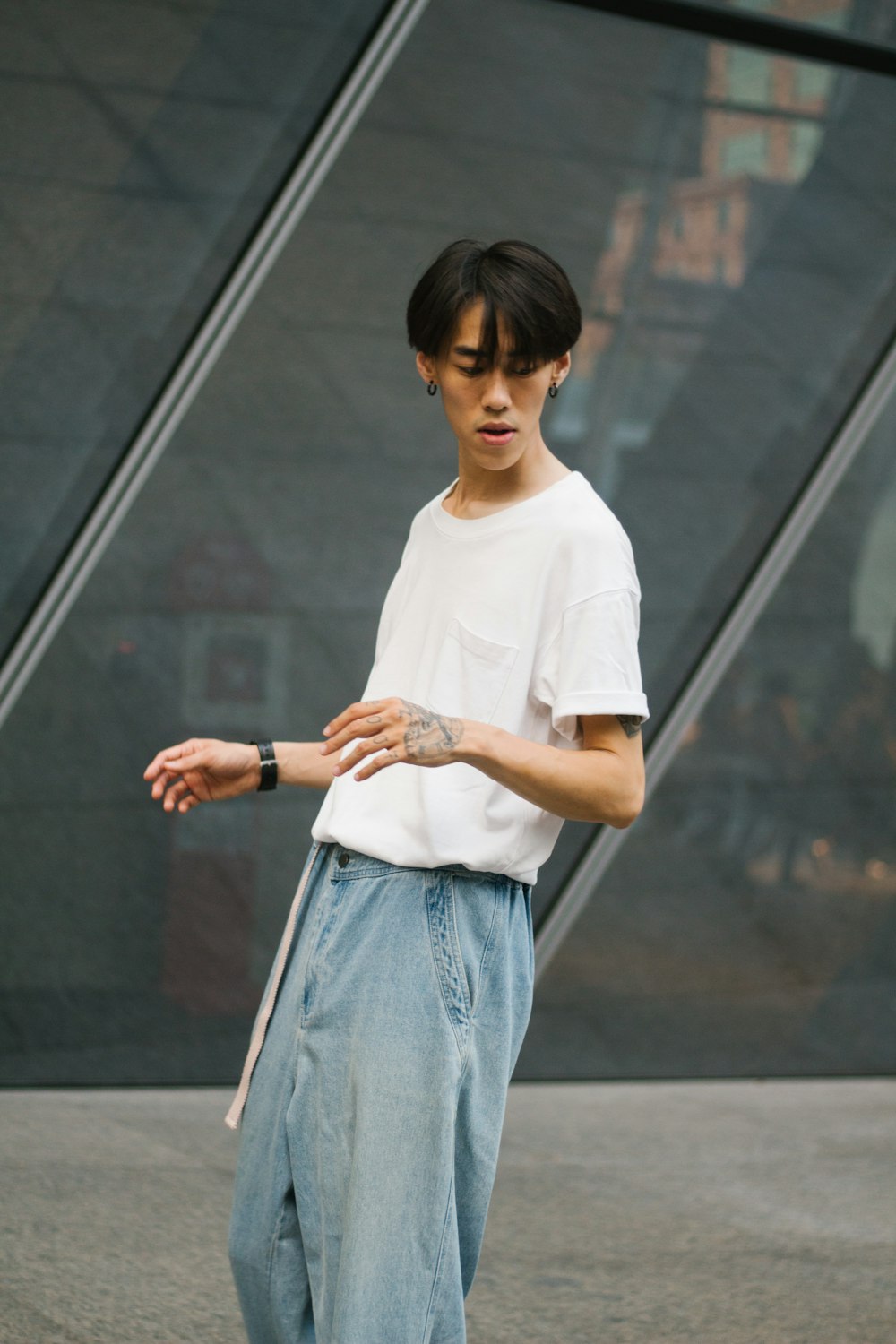 a young man standing on a skateboard in front of a building