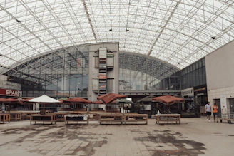 a group of tables and umbrellas in a building