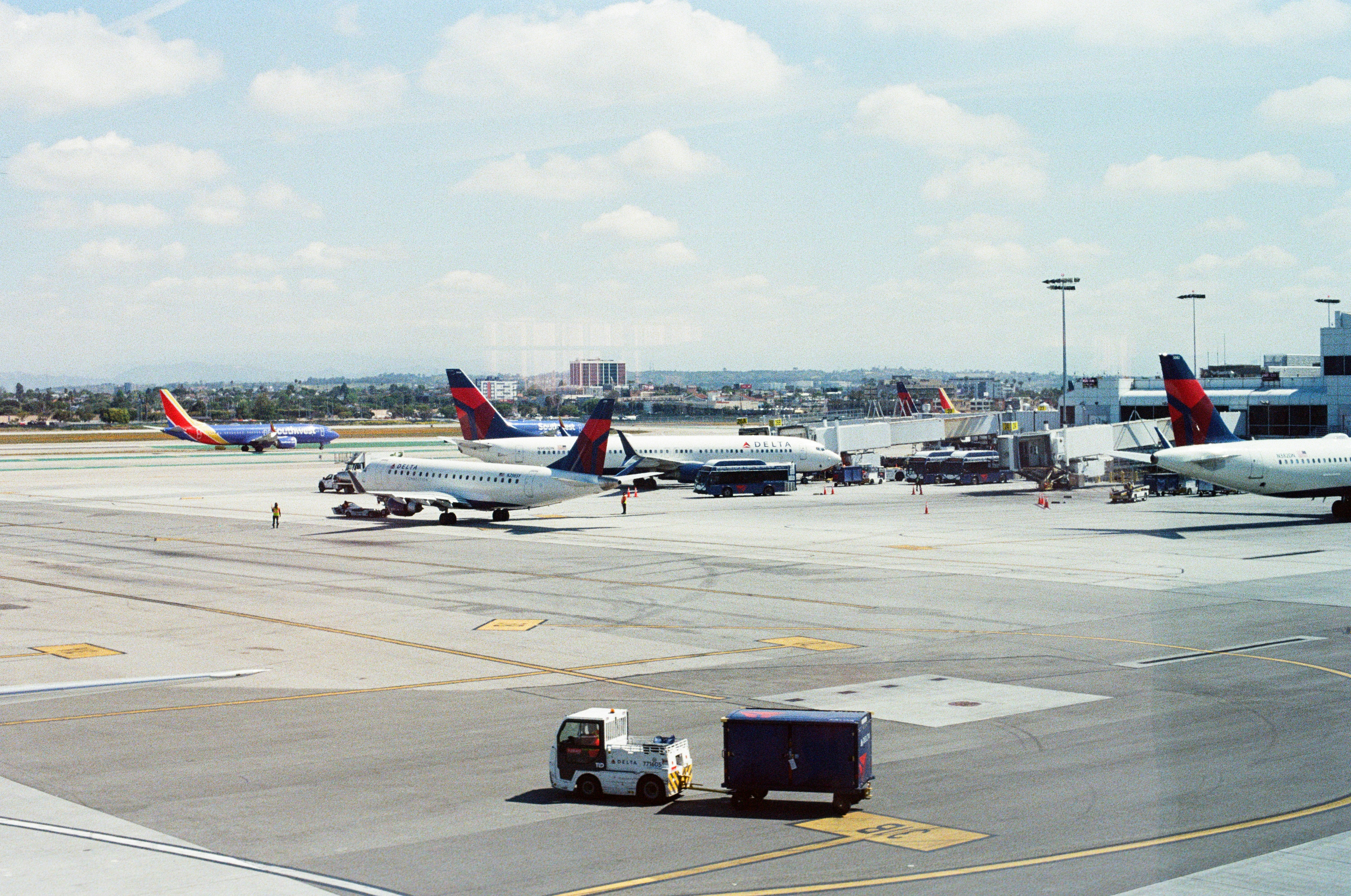 A group of airplanes parked on top of an airport tarmac photo – Free ...