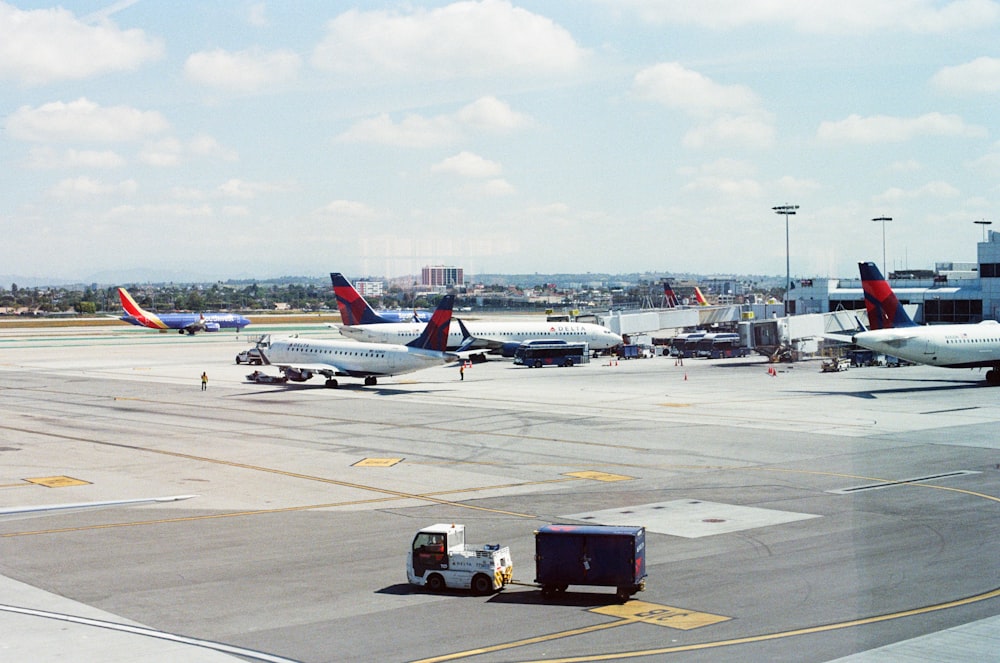 a group of airplanes parked on top of an airport tarmac