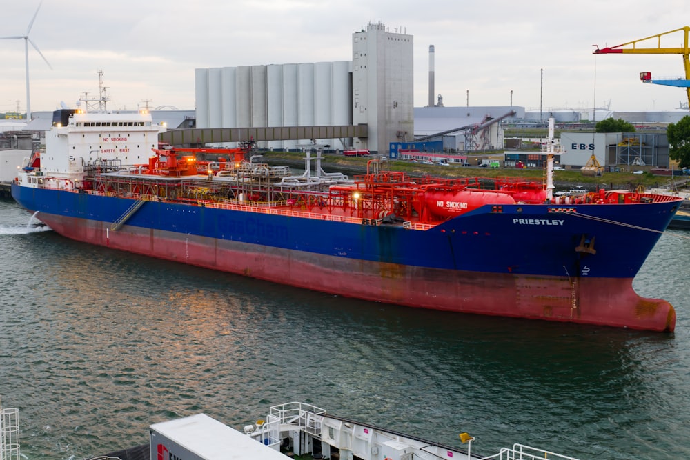 a large blue and red boat in the water