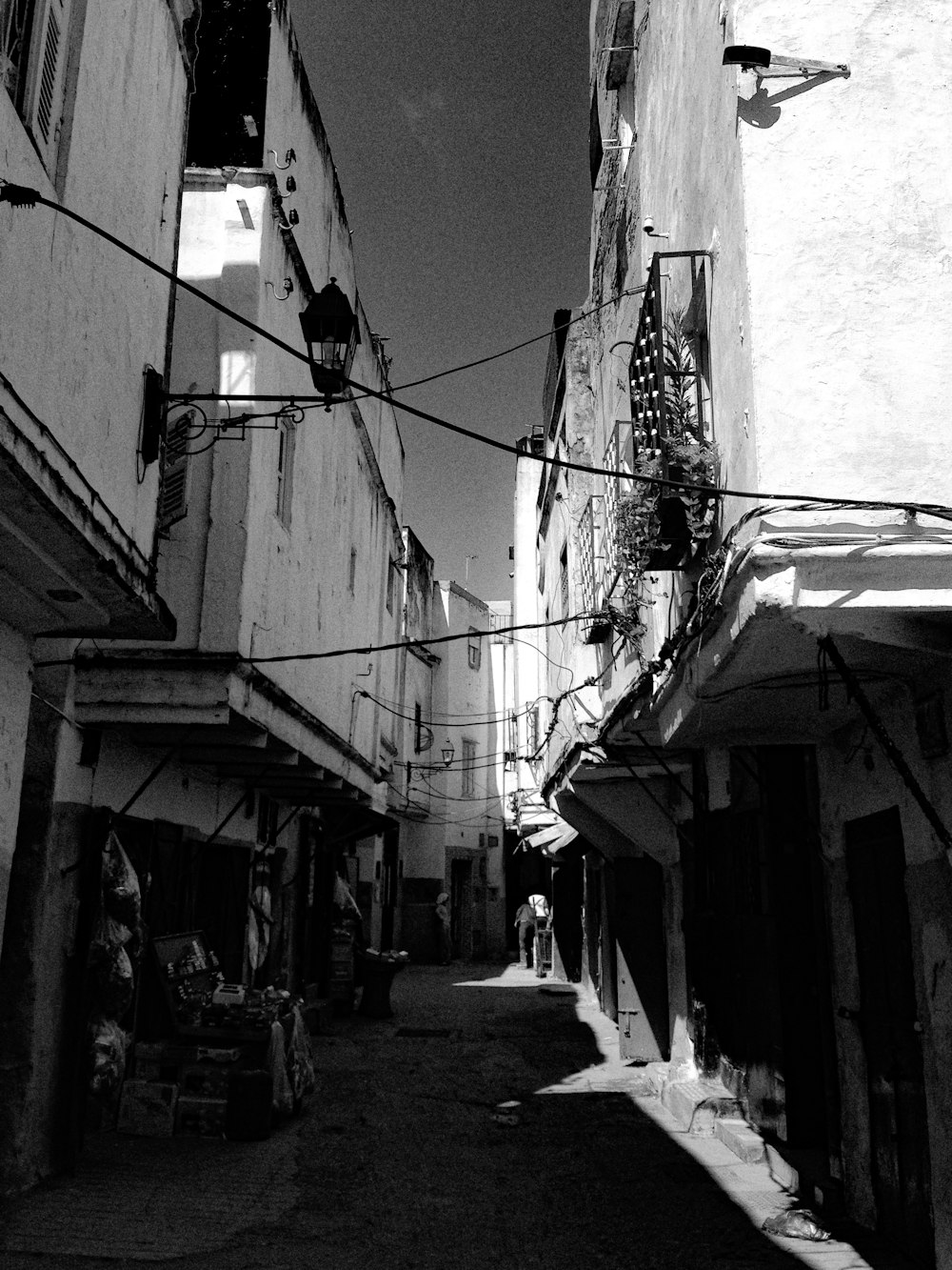 a black and white photo of a narrow street