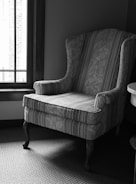 a chair sitting next to a window in a room
