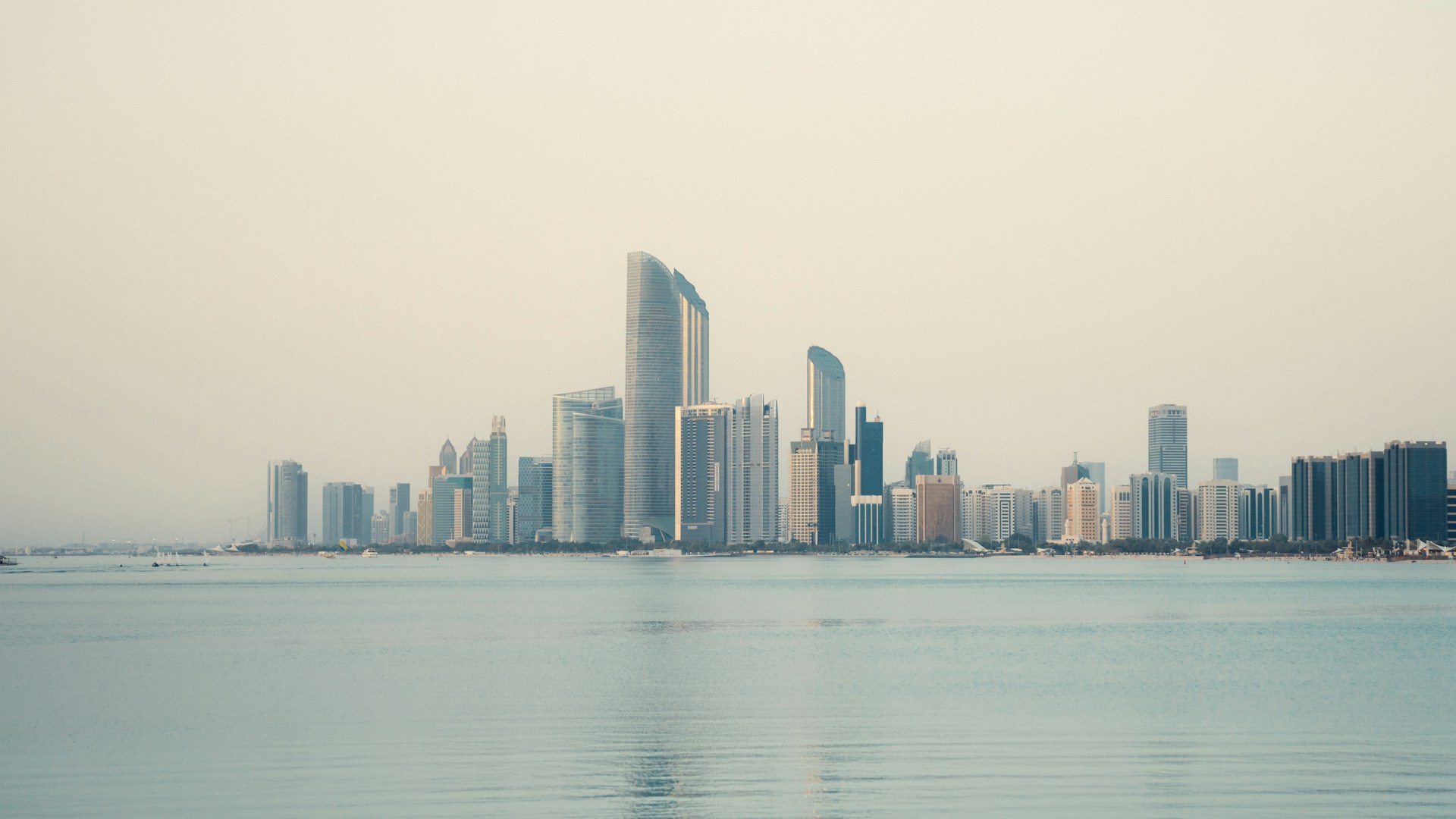 a large body of water with a city in the background