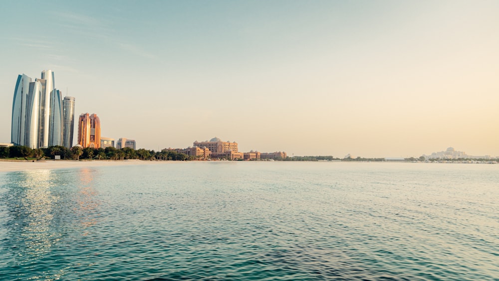 a body of water with buildings in the background