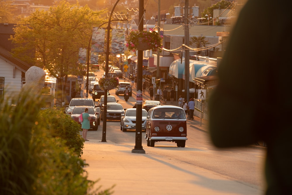 a small red car driving down a street