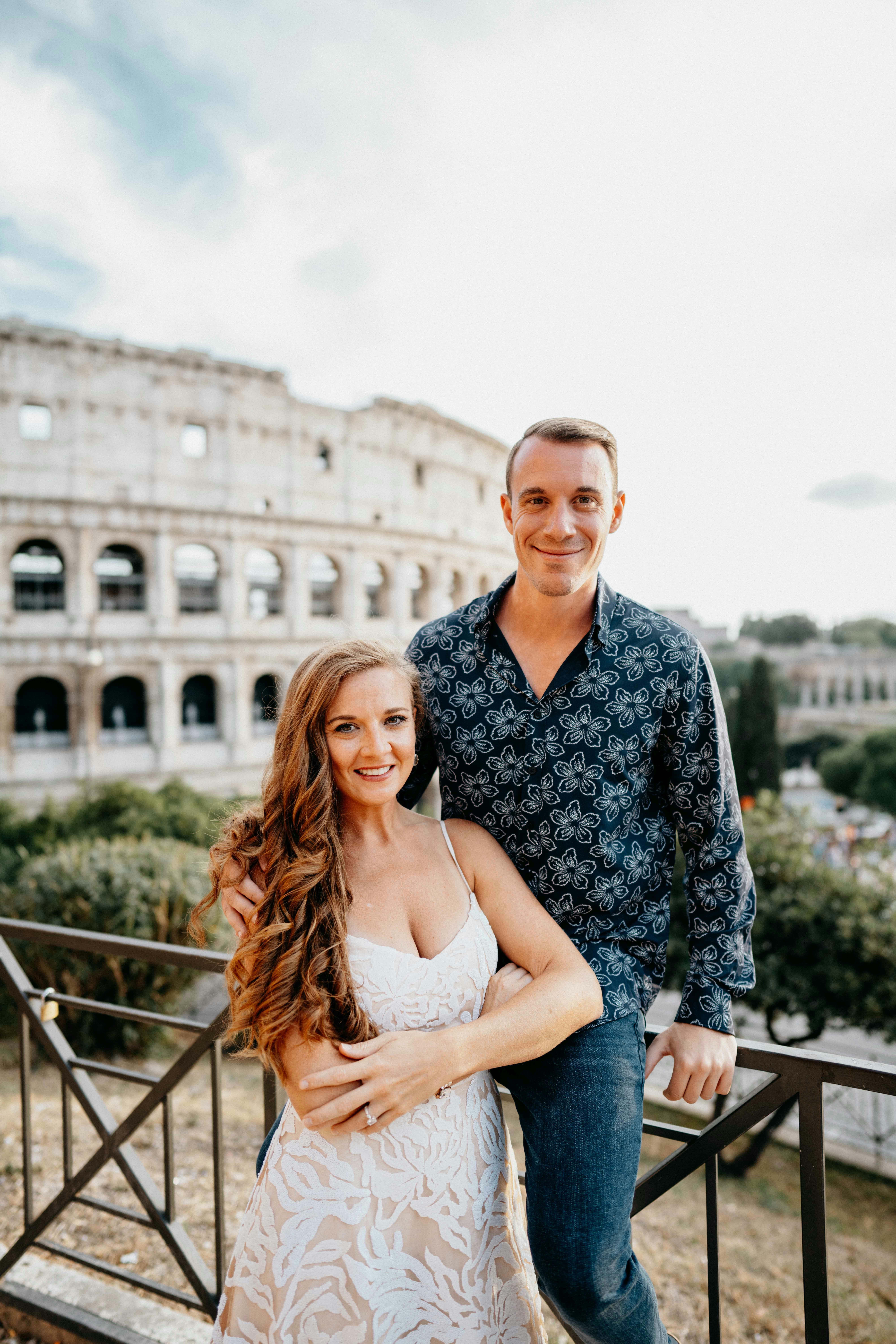 great photo recipe,how to photograph couple in front of the roman colosseum, rome italy. happy couple, smiling couple, couple holding each other. alecia sanfilippo and alex sanfilippo founder of podpros, podpros.com; a man and a woman standing next to each other