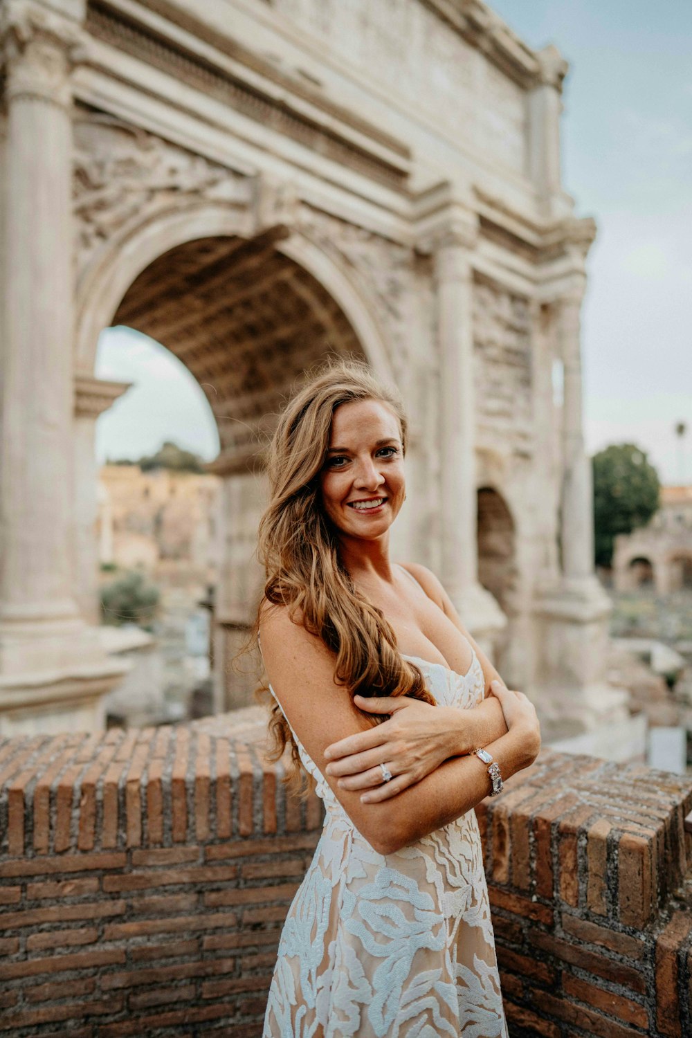 a woman standing in front of an arch of triumph