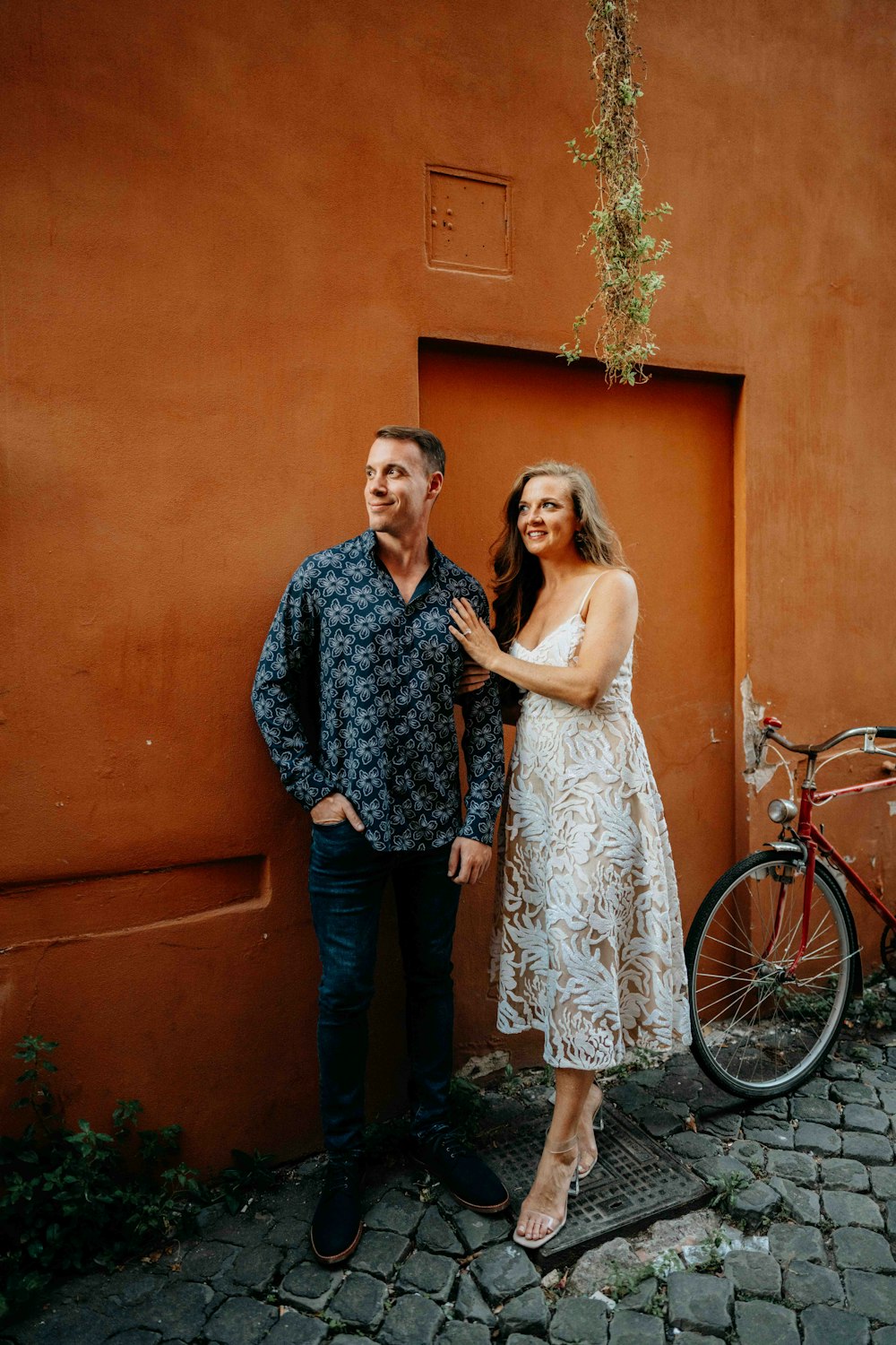 a man standing next to a woman near a bike