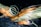 A detailed view of a sci-fi spacecraft with an orange and white body. The design features large circular thrusters and angular wings. The background is a starry space scene, enhancing the futuristic theme of the image.