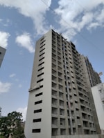 a tall building under a cloudy blue sky