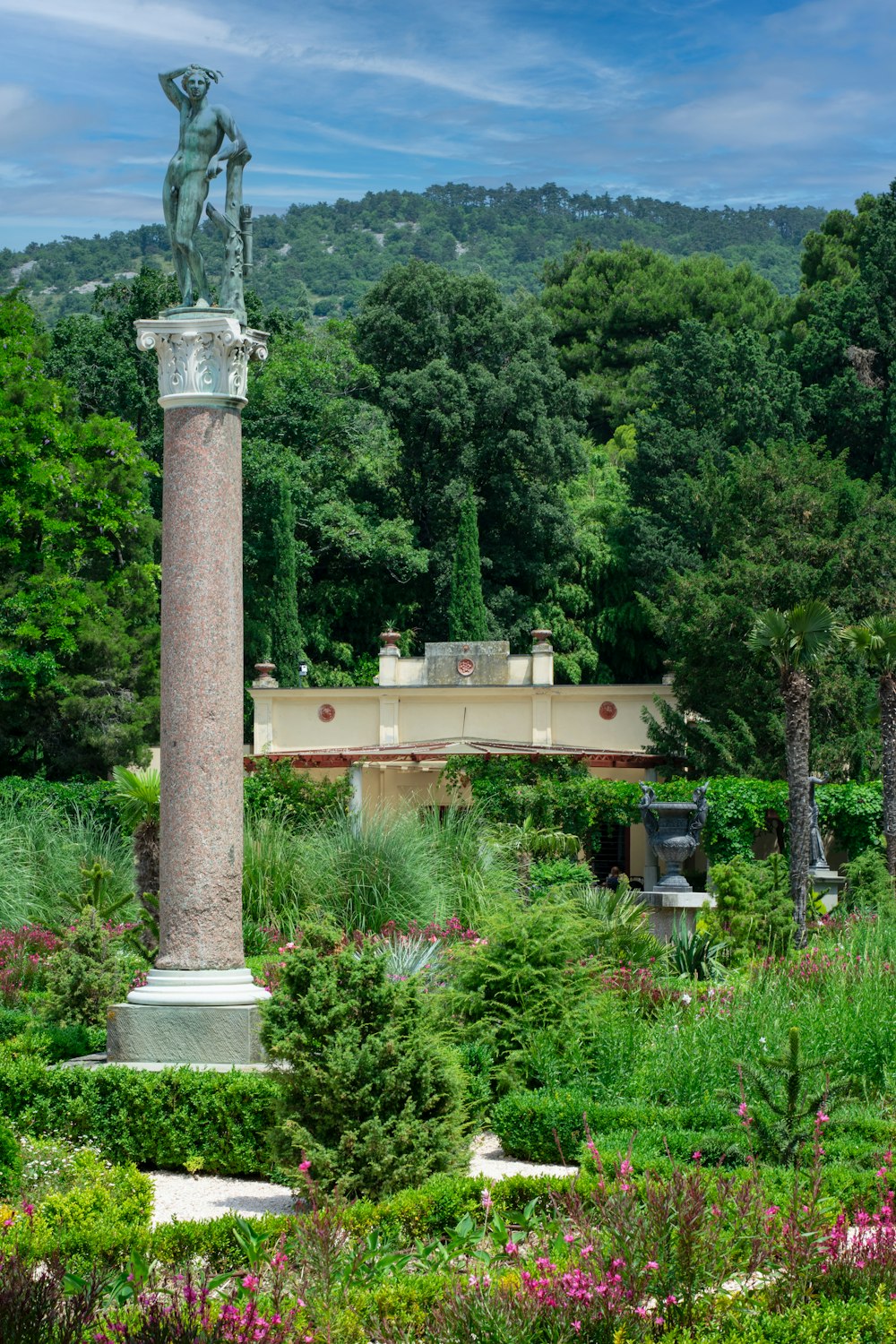 a statue in the middle of a garden