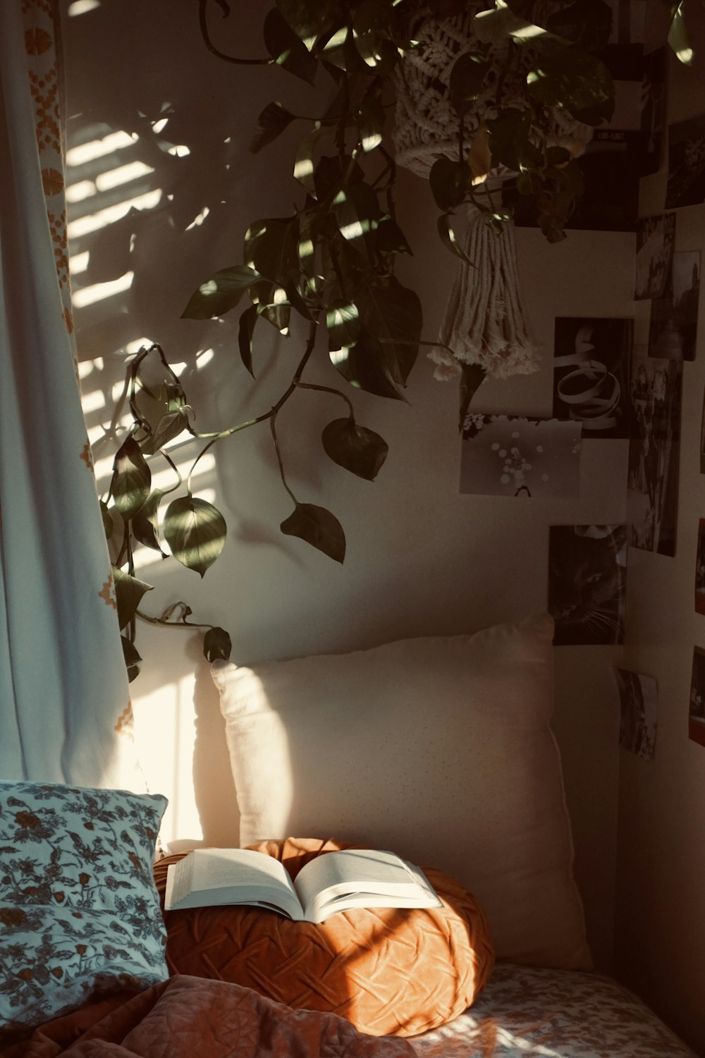 a bed with a book on top of it next to a window