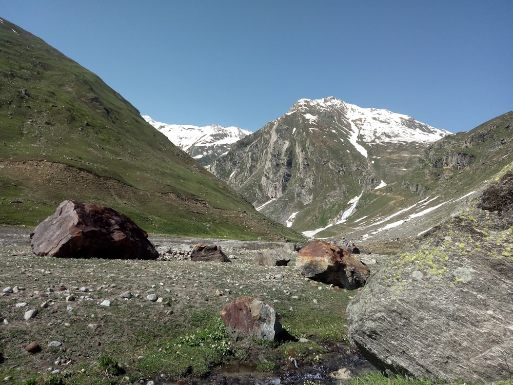 a view of a mountain range with a stream running through it