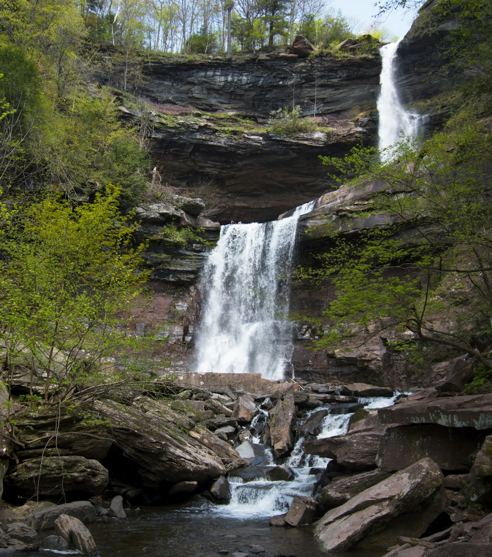 a large waterfall in the middle of a forest