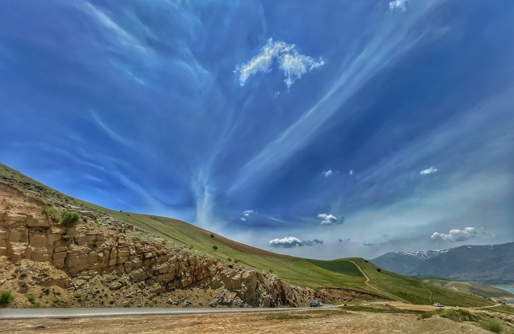 a scenic view of a mountain with a blue sky