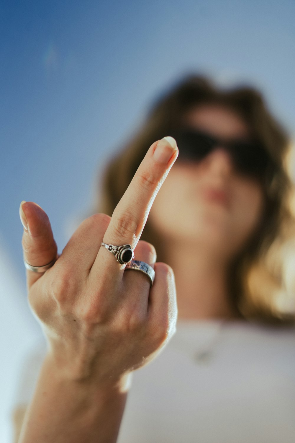 a woman making a peace sign with her finger