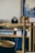 A golden balance scale with an ornate eagle decoration on top is partially visible against a blurred background of bookshelves. The background includes hints of books and a framed picture.