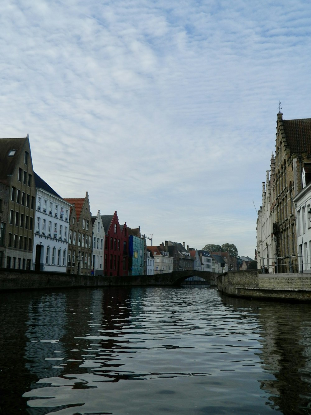 a river running through a city next to tall buildings