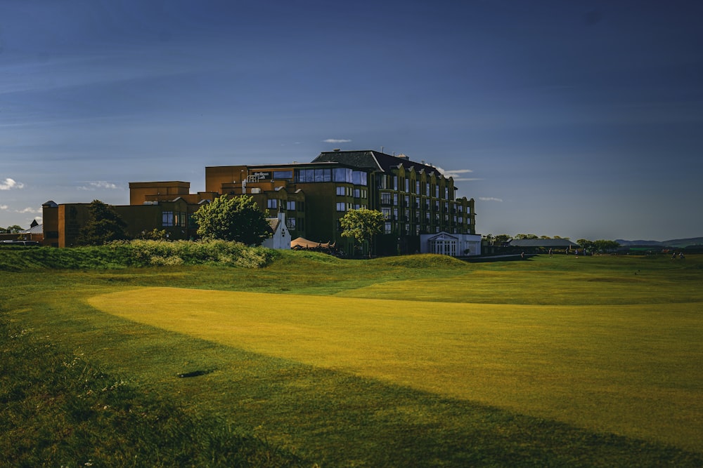 a golf course with a building in the background