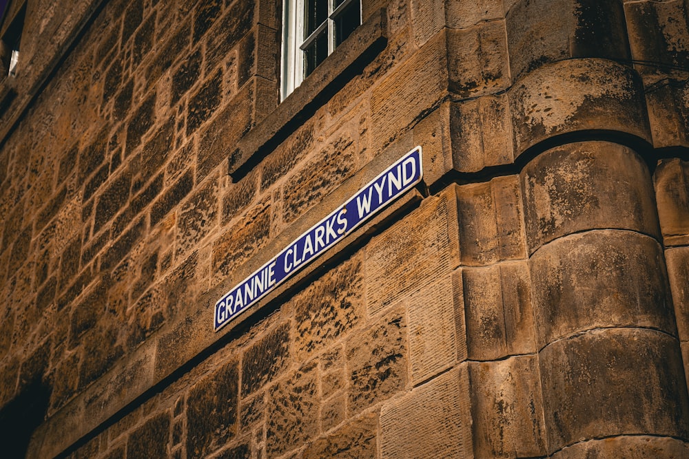 a close up of a street sign on the side of a building