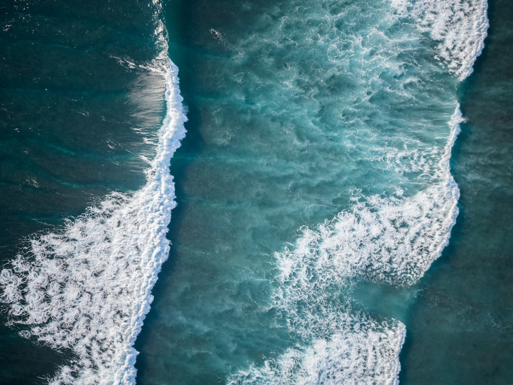 an aerial view of the ocean with waves