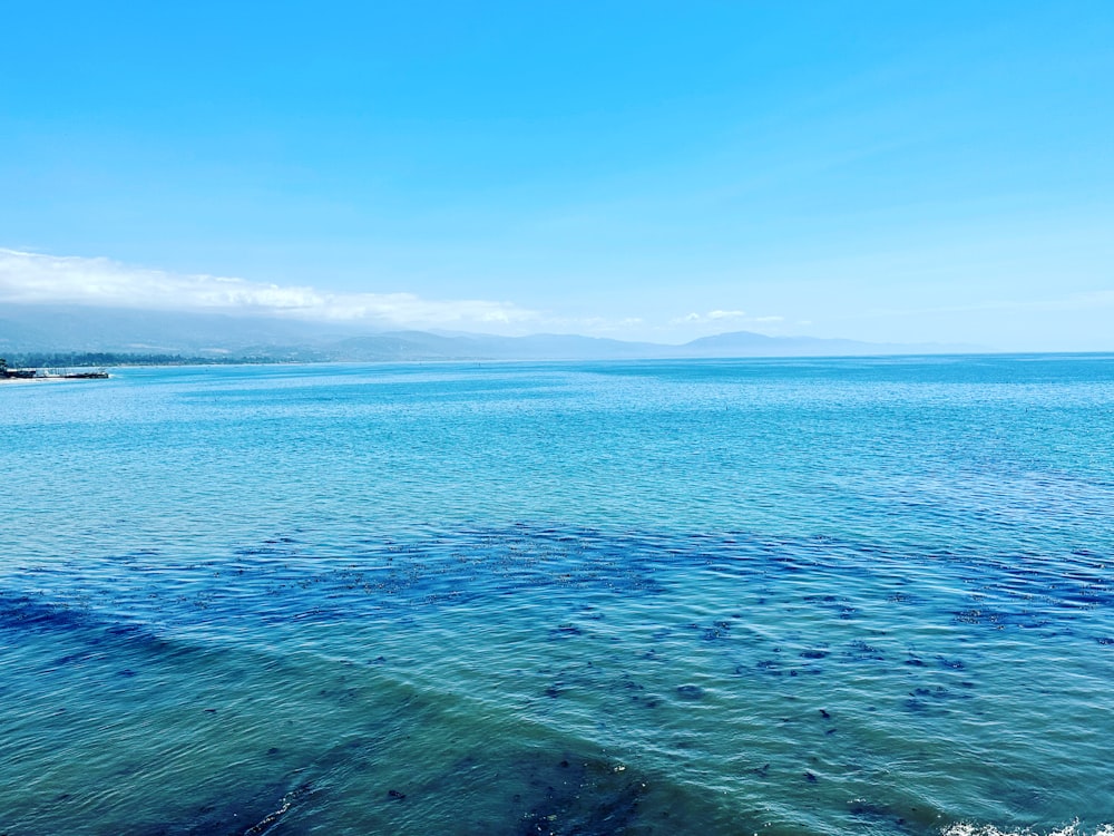 a body of water with a boat in the distance