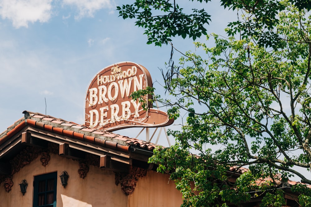 a brown derby sign on top of a building