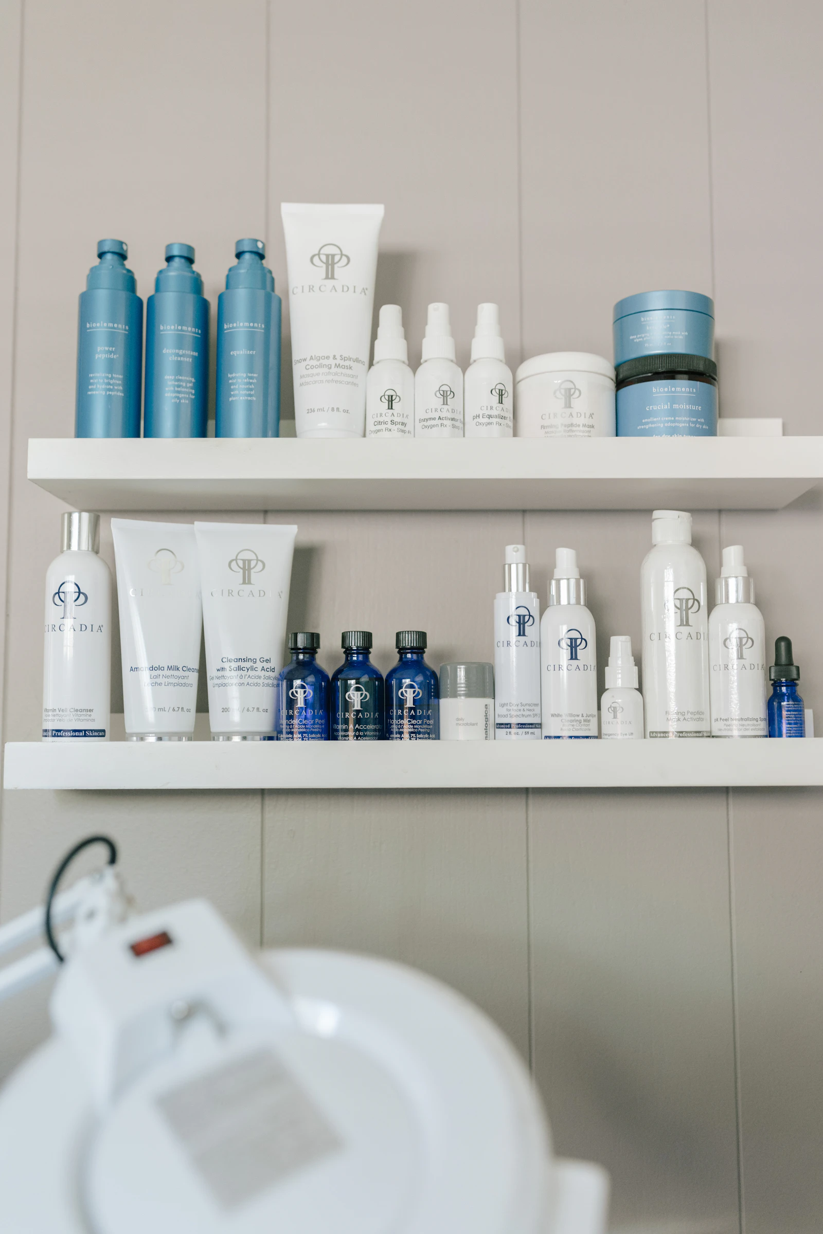 A shelf stocked with an assortment of skincare product bottles, representing a clinical skincare range comparison