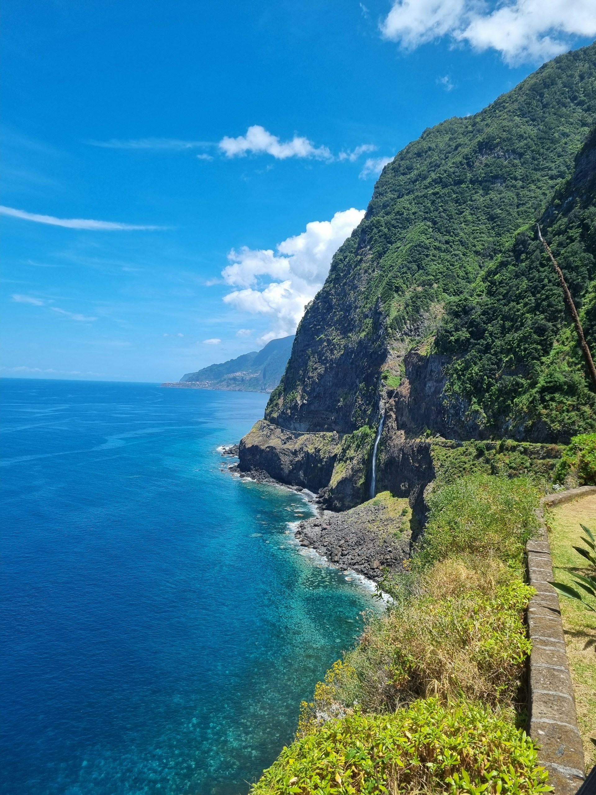 a scenic view of the ocean and mountains