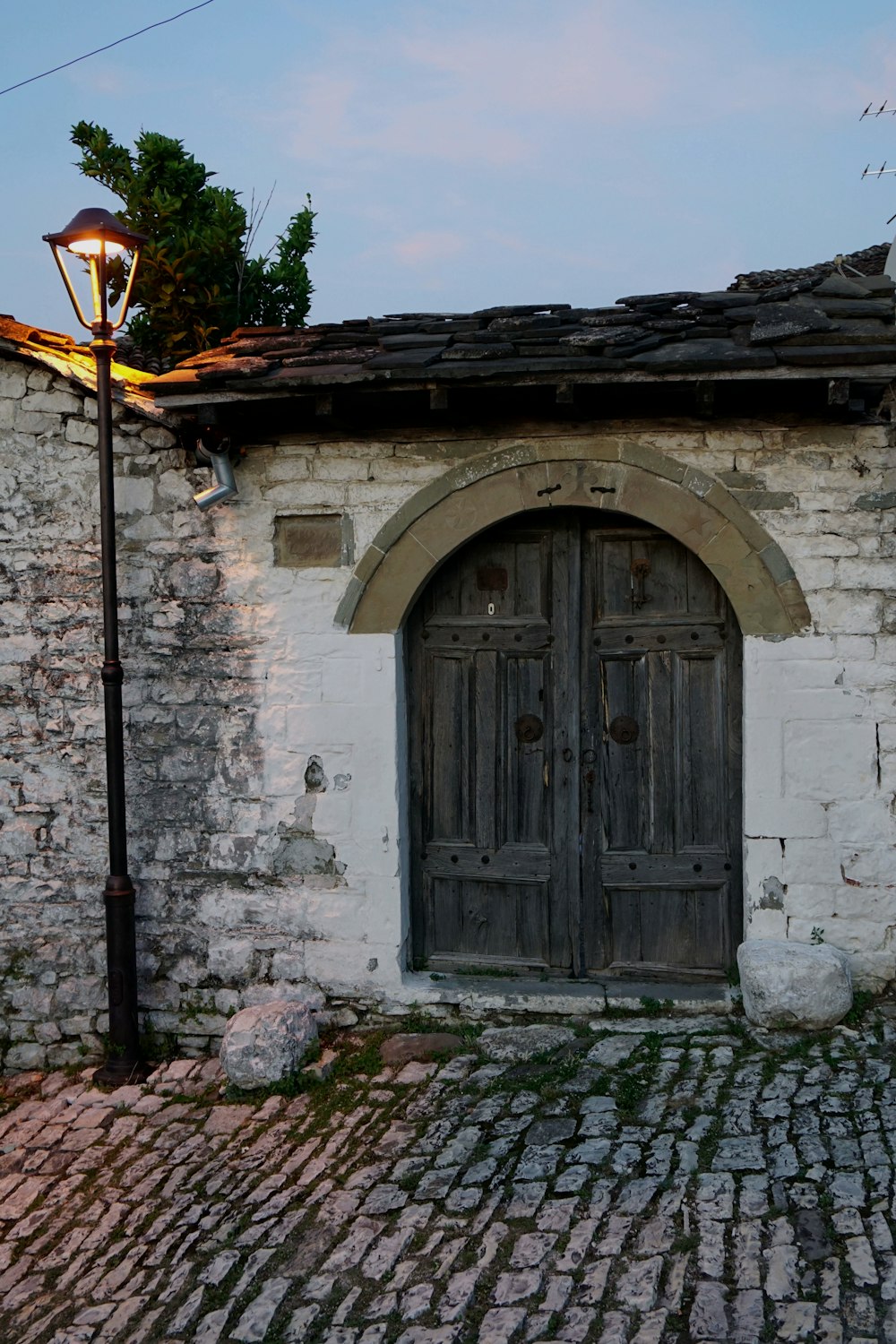 an old stone building with a wooden door