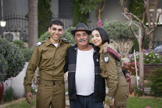 Veteran paratroopers gathered outdoors sharing stories and camaraderie.