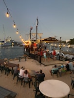A fun pirate ship with children and adults dressed in pirate costumes.