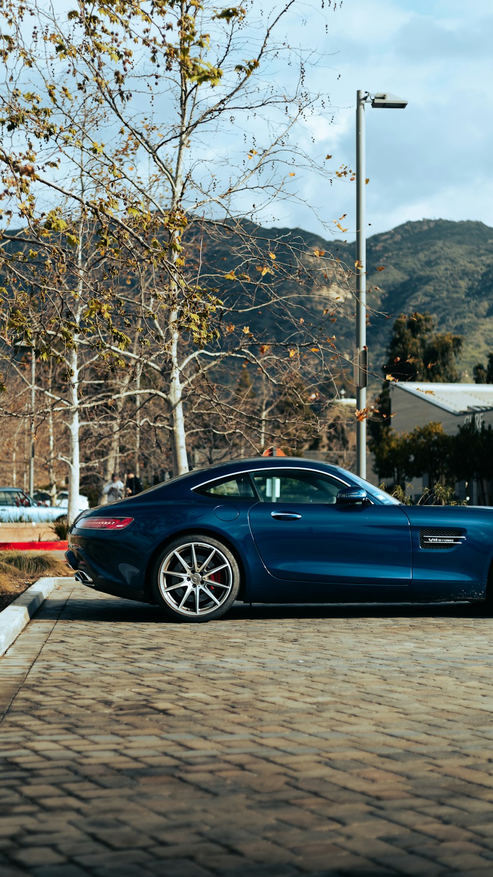 a blue sports car parked in a parking lot