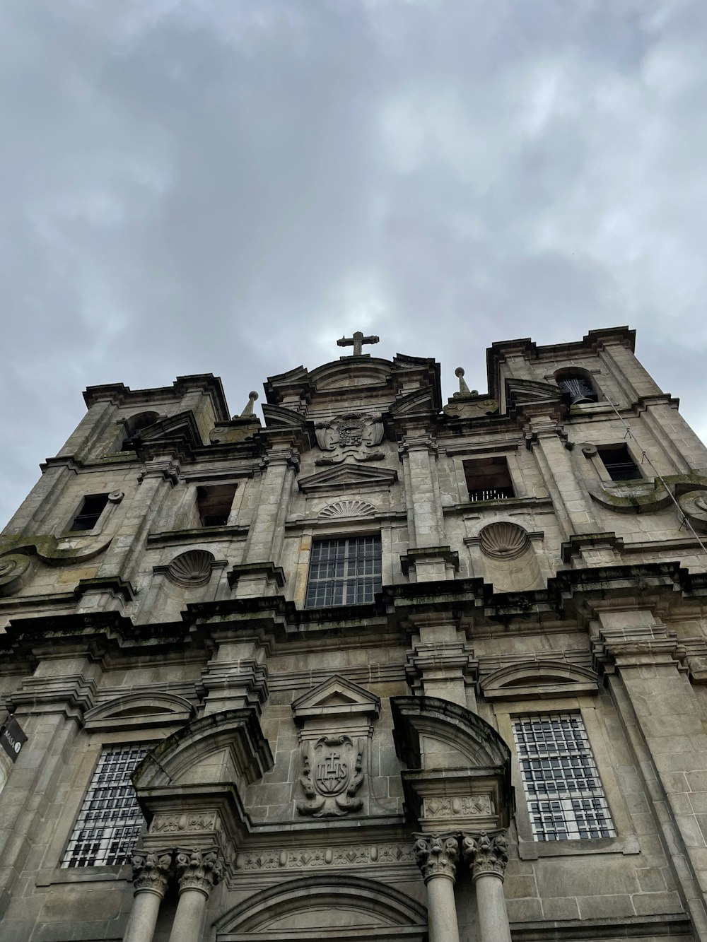 a tall building with a cross on the top of it