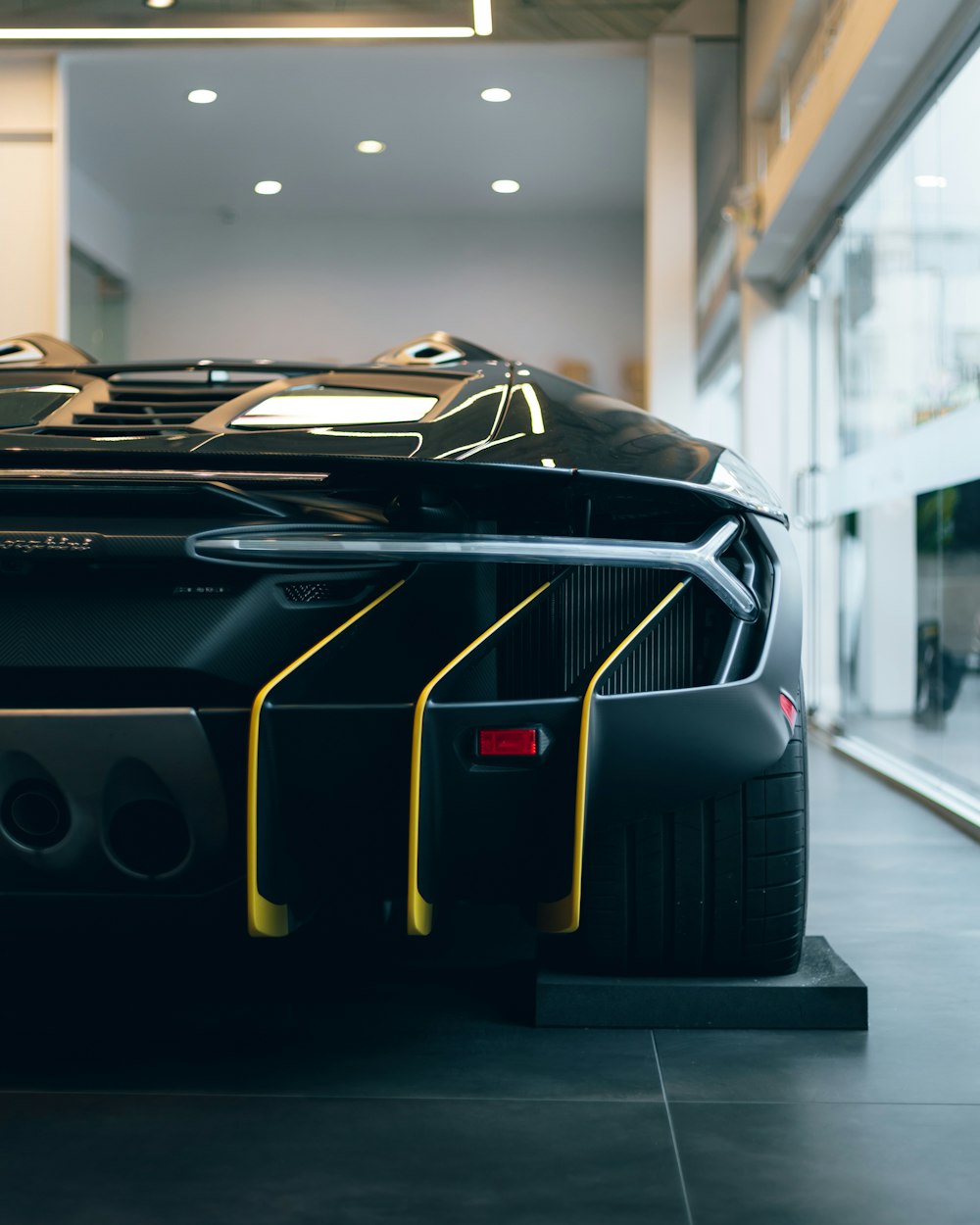 a black sports car parked inside of a building