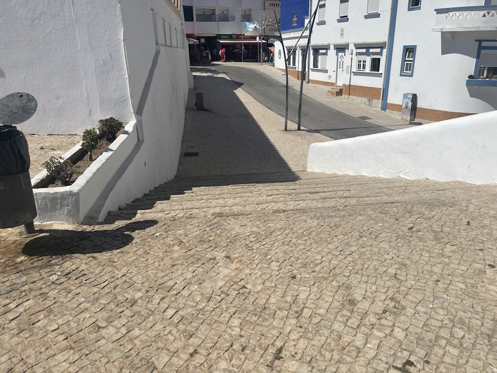 a cobblestone street with a building in the background