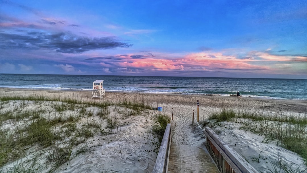 a beach with a path leading to the ocean, Sunset over the Atlantic ocean by Bogue Sound beach in North Carolina.