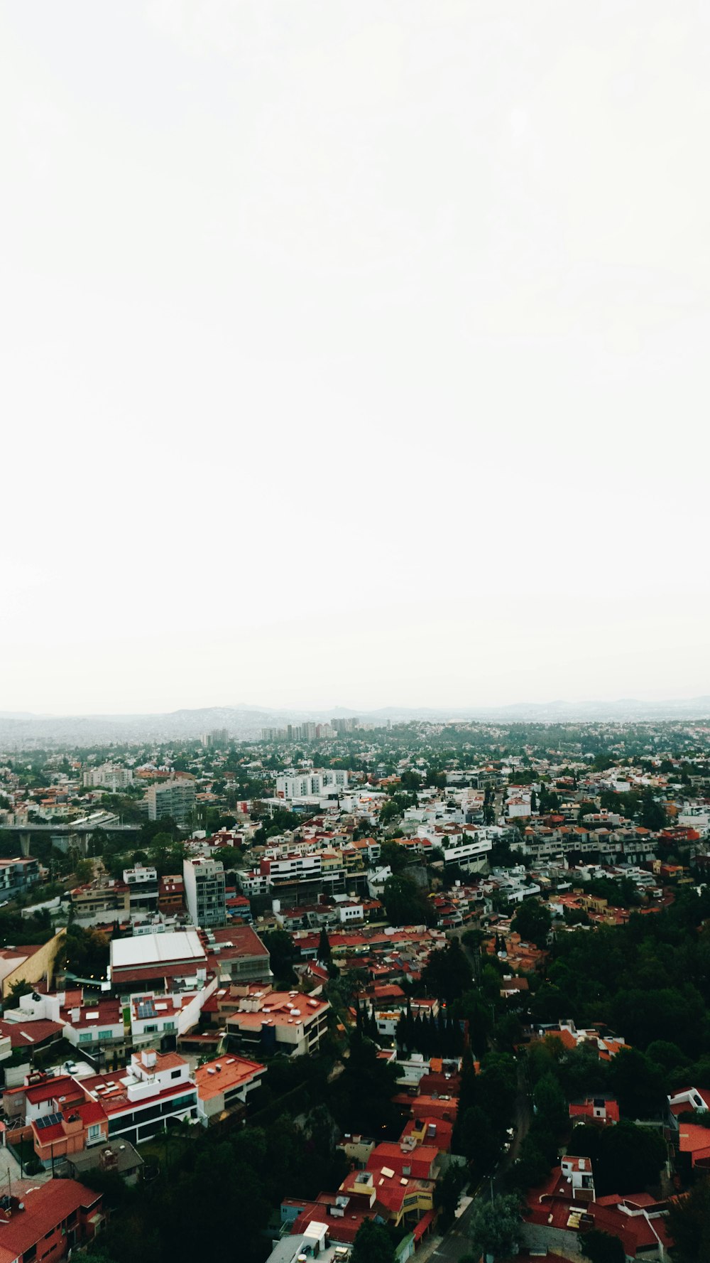 an aerial view of a city with red roofs