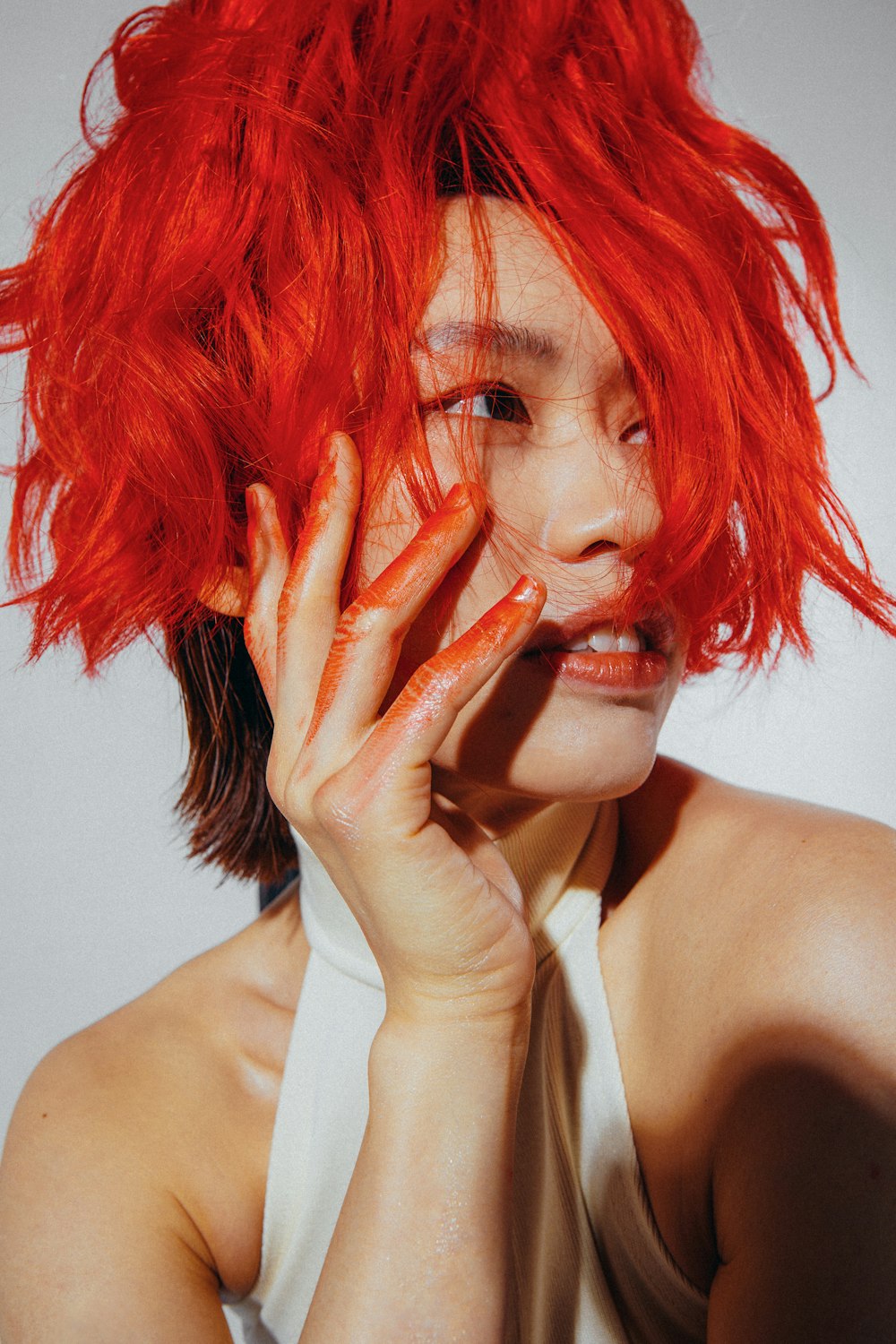 a woman with bright red hair is posing for a picture