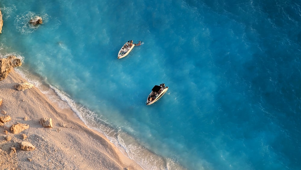 a couple of boats floating on top of a body of water