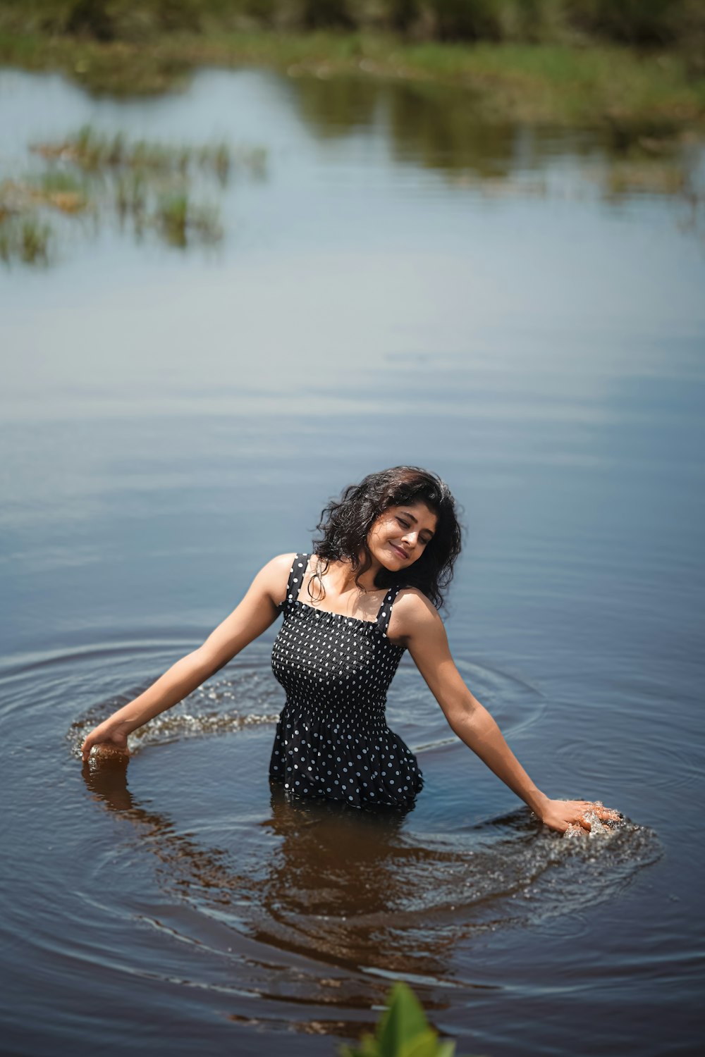 a woman standing in a body of water