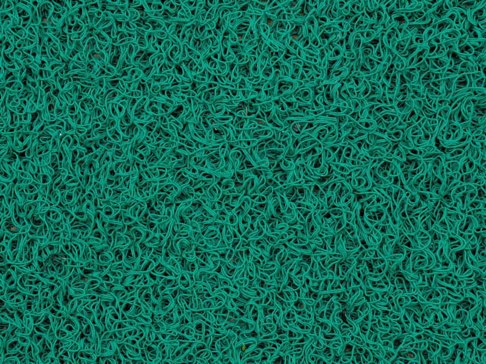 a close up of a green surface with lots of lines