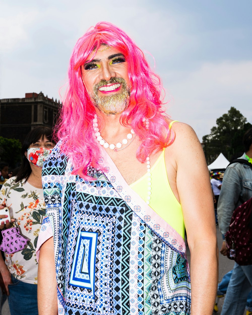 a man with pink hair and a pink wig
