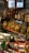 A variety of liquor bottles are displayed on the top shelf, including brands like Johnnie Walker, Gordon’s, and others. Below them, there are several packs of pasta with yellow and green packaging, stacked neatly. The background includes a refrigerated section with drink bottles.