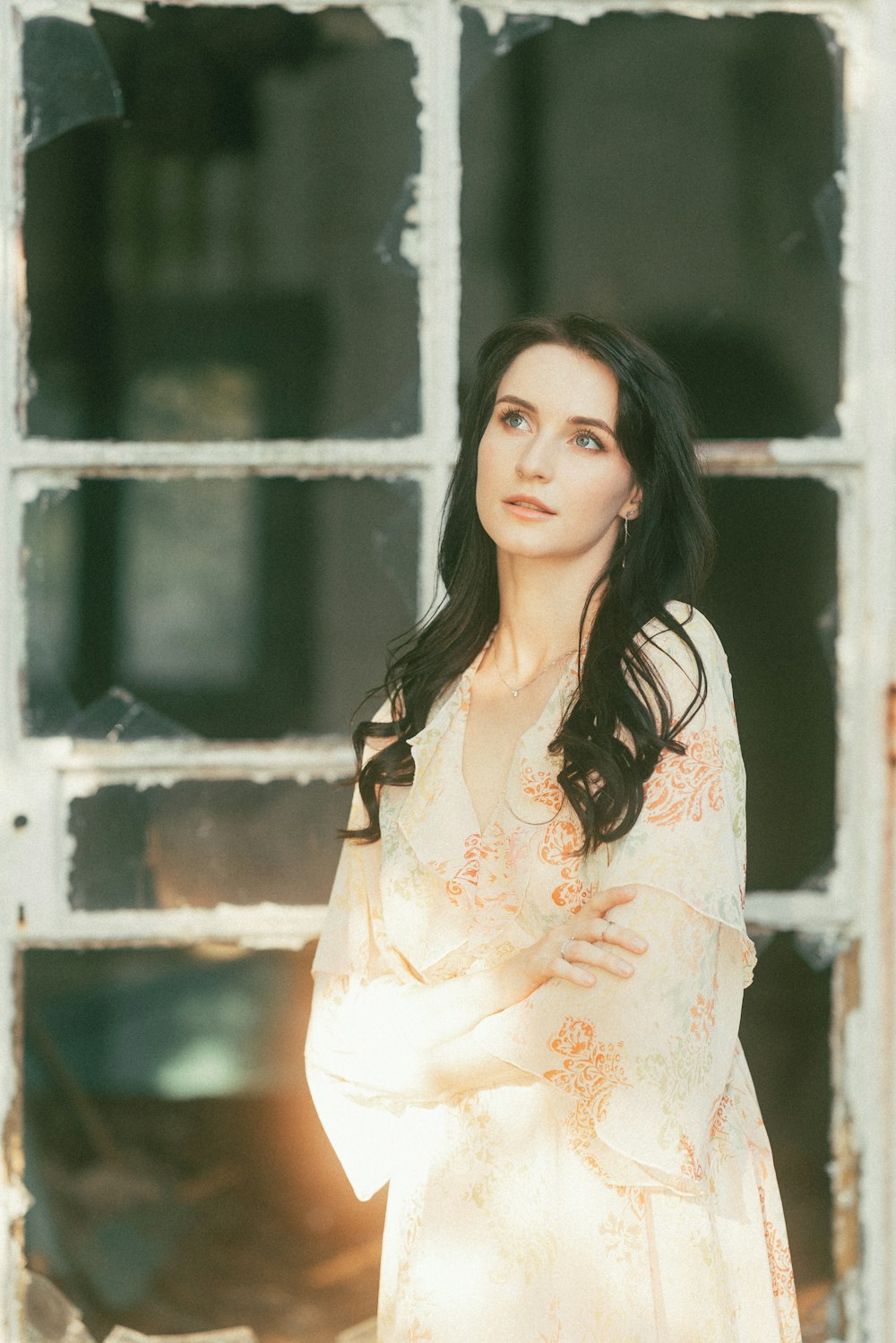 a woman standing in front of a window