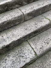 Before and after images of a restored outdoor granite step showing vibrant color and smooth texture.