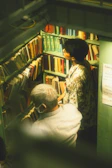 Two members exchanging books in a cozy home setting.