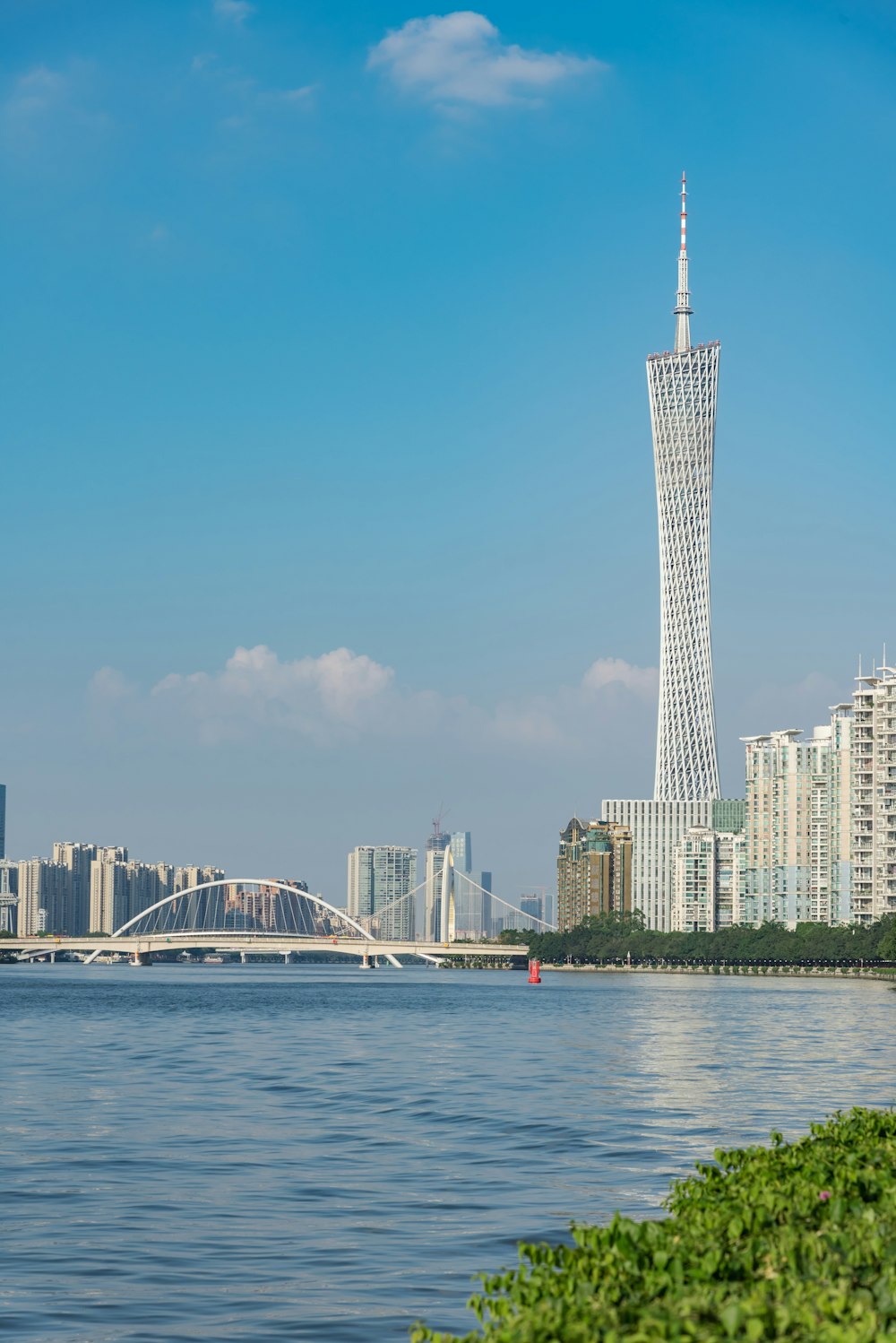 a large body of water with a tall building in the background