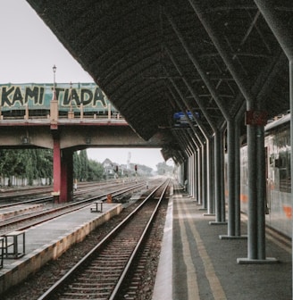 a train station with a train on the tracks